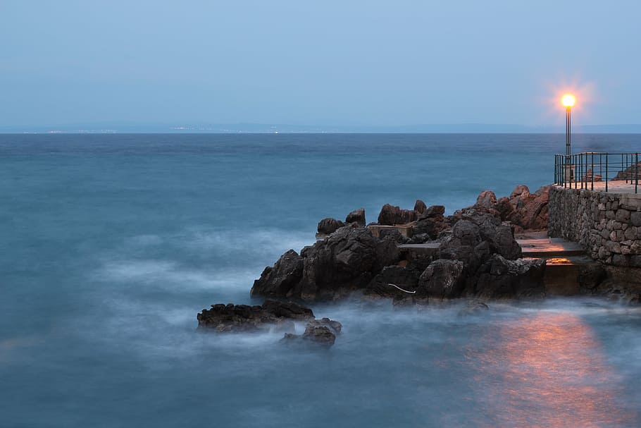 calm sea and lighted lamp post under clear blue sky, landscape HD wallpaper