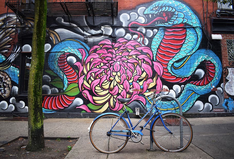 blue bicycle parked near graffiti, photo of blue step-through frame bike
