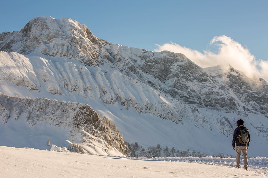 man facing snow covered mountain, man walking on snowy field HD wallpaper