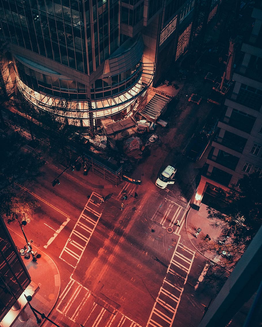 aerial photography of people walking on crossing at nighttime, aerial view of car on asphalt road during nighttime HD wallpaper