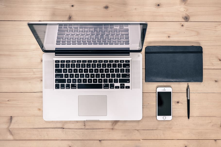 MacBook Pro, silver iPhone 6, and black retractable pen, desk HD wallpaper
