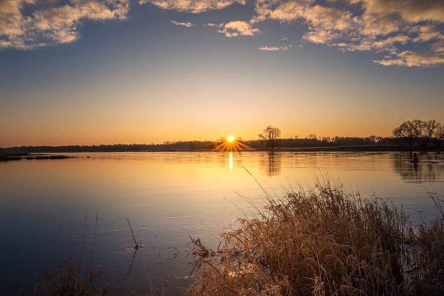 calm body of water under gra y sky during golden hour, sunrise HD wallpaper