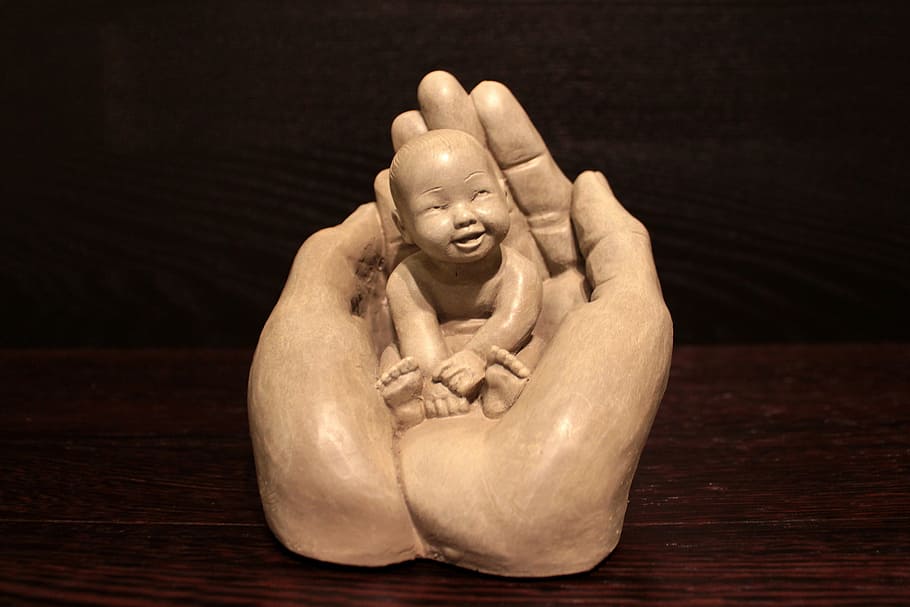 baby on human hand figurine, hands, open, figure, security HD wallpaper