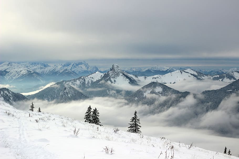 snow covered mountains under grey clouds, aerial view photography of mountain covered by fog HD wallpaper