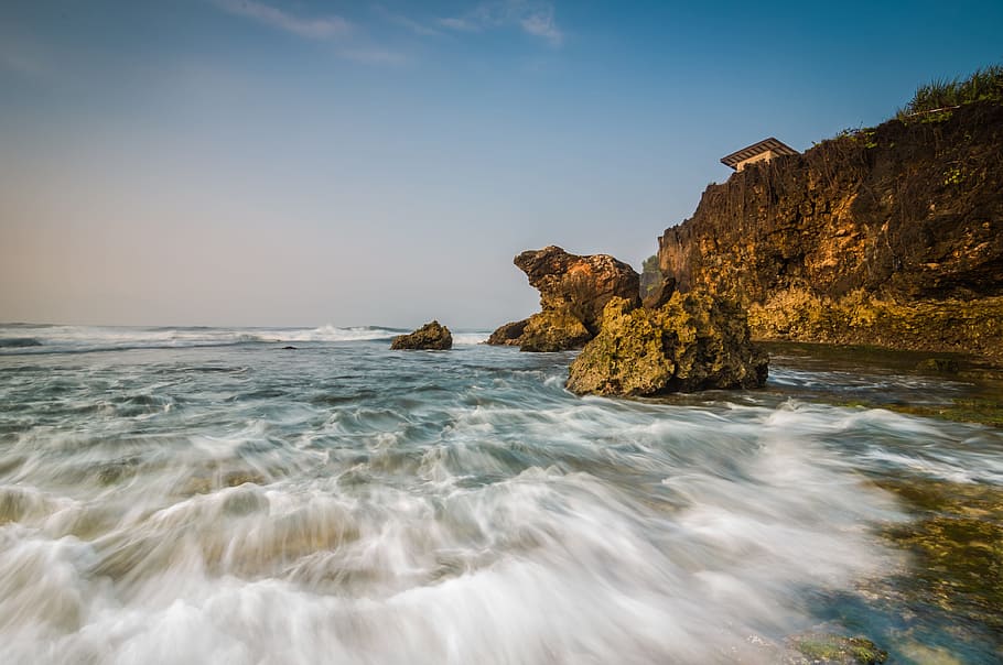 brown rock formation near body of water, beach, rush, tide HD wallpaper