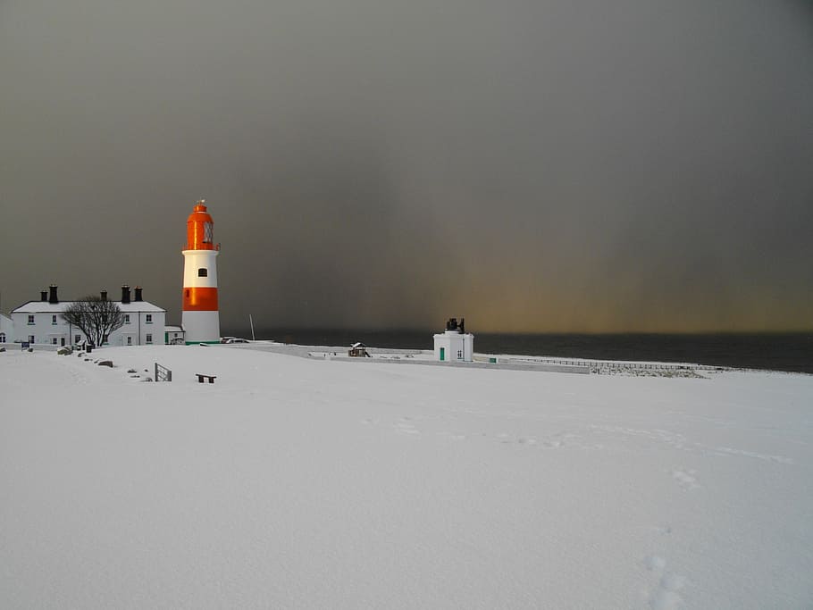 orange and white lighthouse on snow field during daytime, south shields