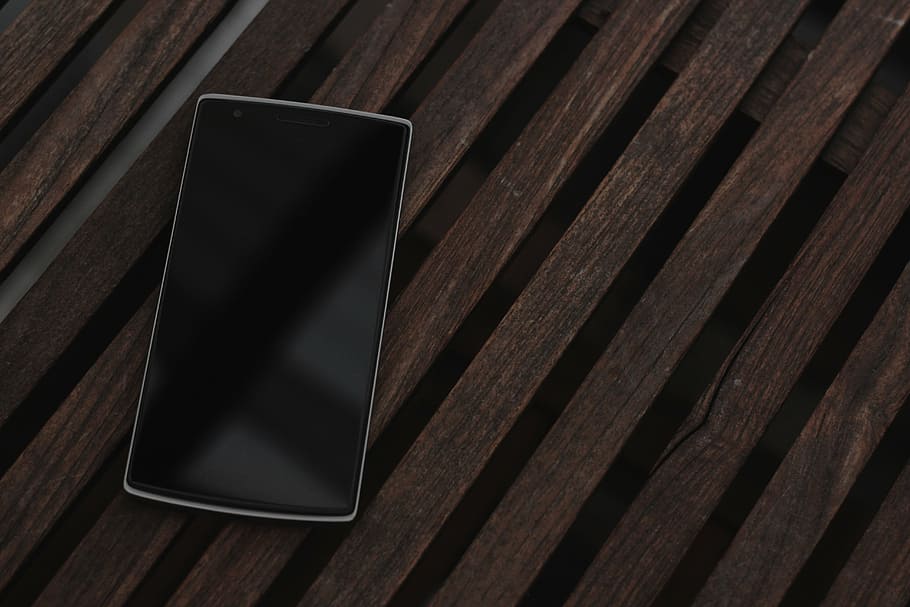 black Android smartphone on brown board, technology, oneplus HD wallpaper