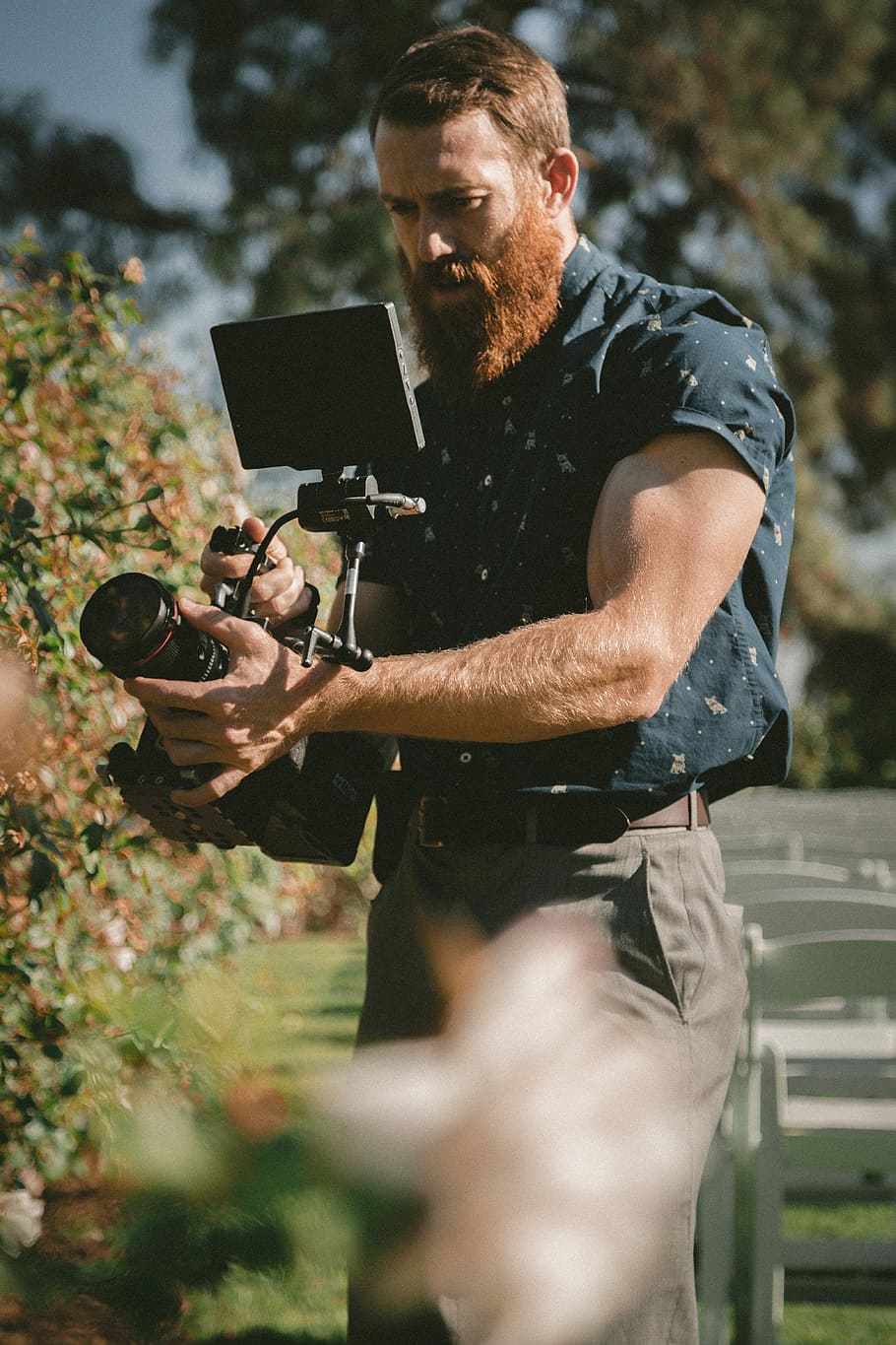 man holding camera taking photos, man holding video camera while taking photo HD wallpaper