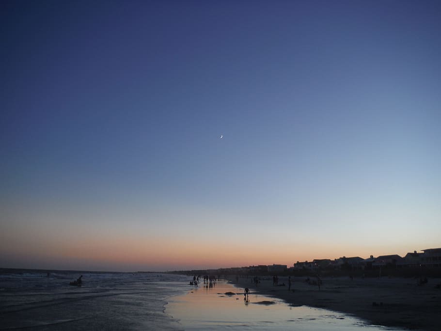 beach with lots of people during dawn, seashore during golden hour HD wallpaper