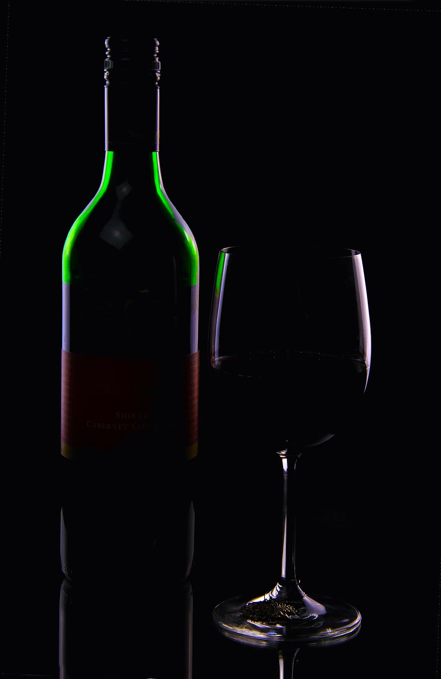 green purple and red glass bottle beside clear footed glass HD wallpaper