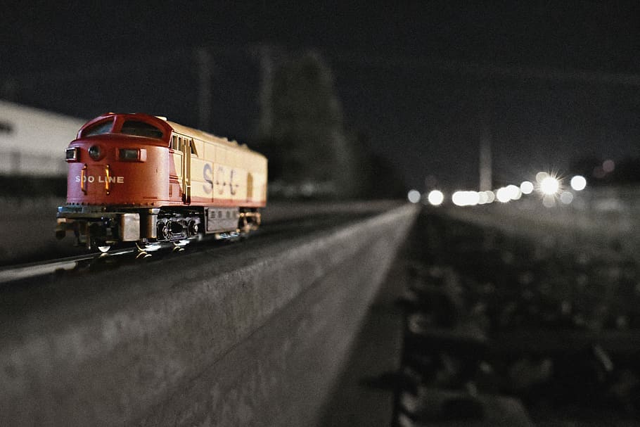shallow focus photography of red and yellow train toy, selective focus photograph of red train toy on rail HD wallpaper
