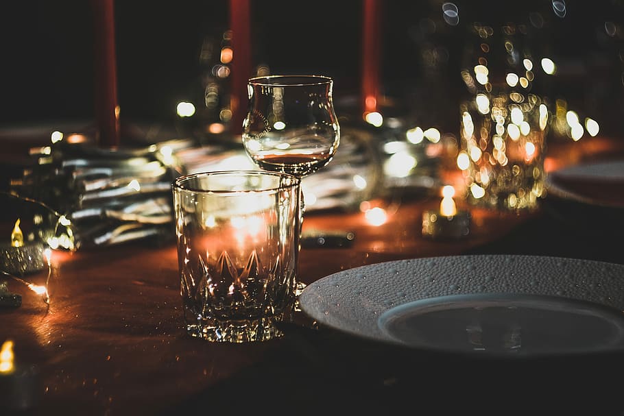 Bokeh night, wine glass near plate and drinking glass on table HD wallpaper