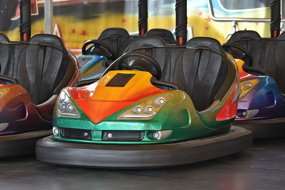 green, orange, and gray arcade karts, bumper cars, ride, fair