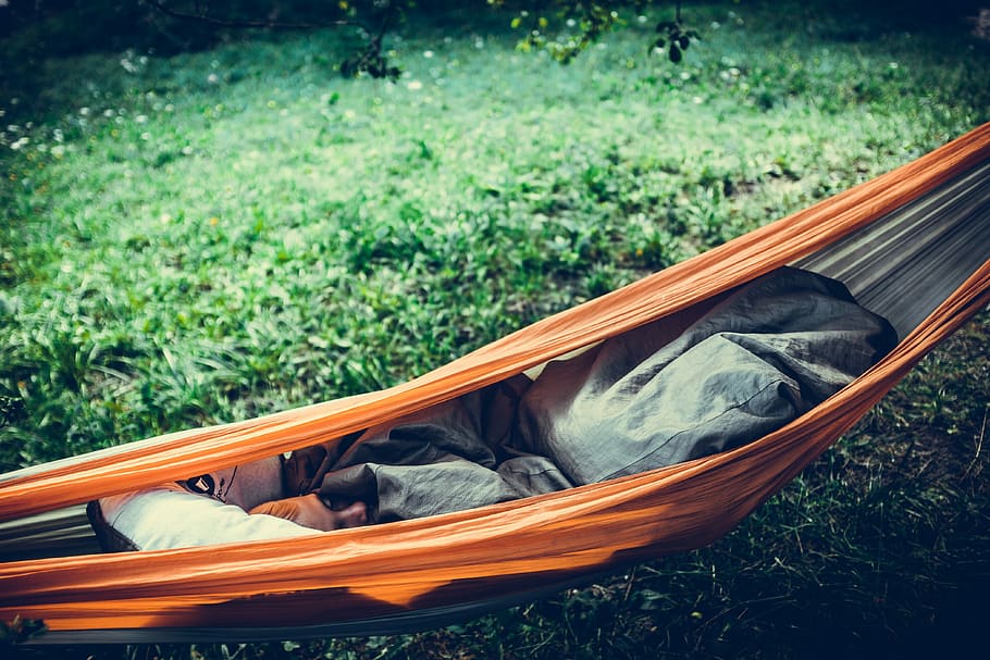 person lying on orange hammock outdoors, person sleeping in hammock HD wallpaper