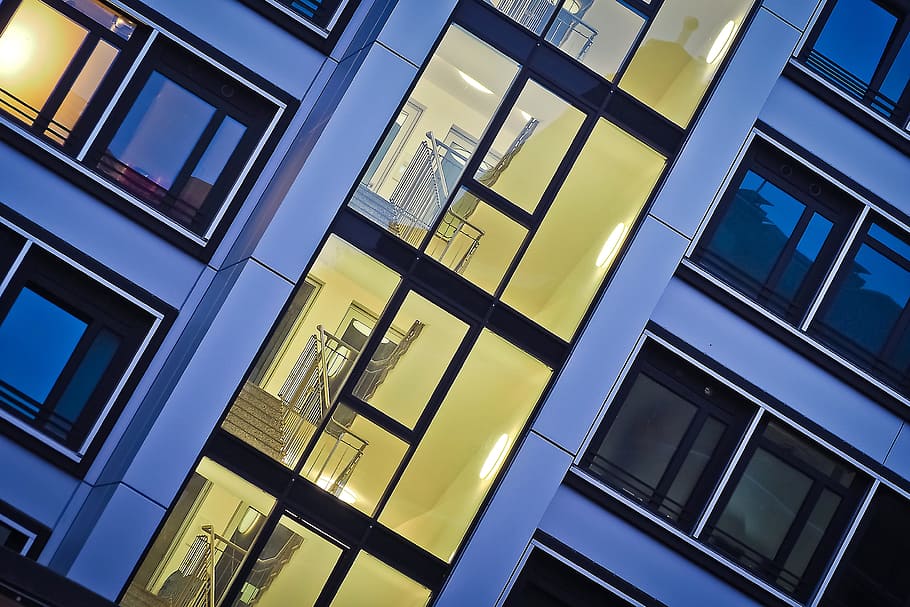 clear glass building showing staircases and rooms in close-up photo HD wallpaper