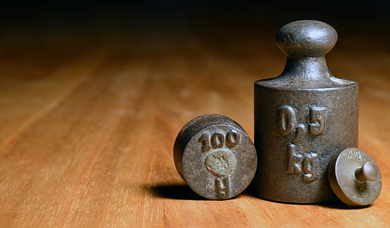 cylindrical black metal tool on brown wooden board, weights HD wallpaper