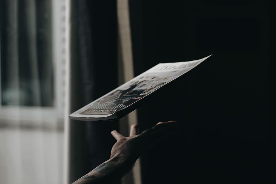 person throwing up labeled book, person catching magazine, hand HD wallpaper