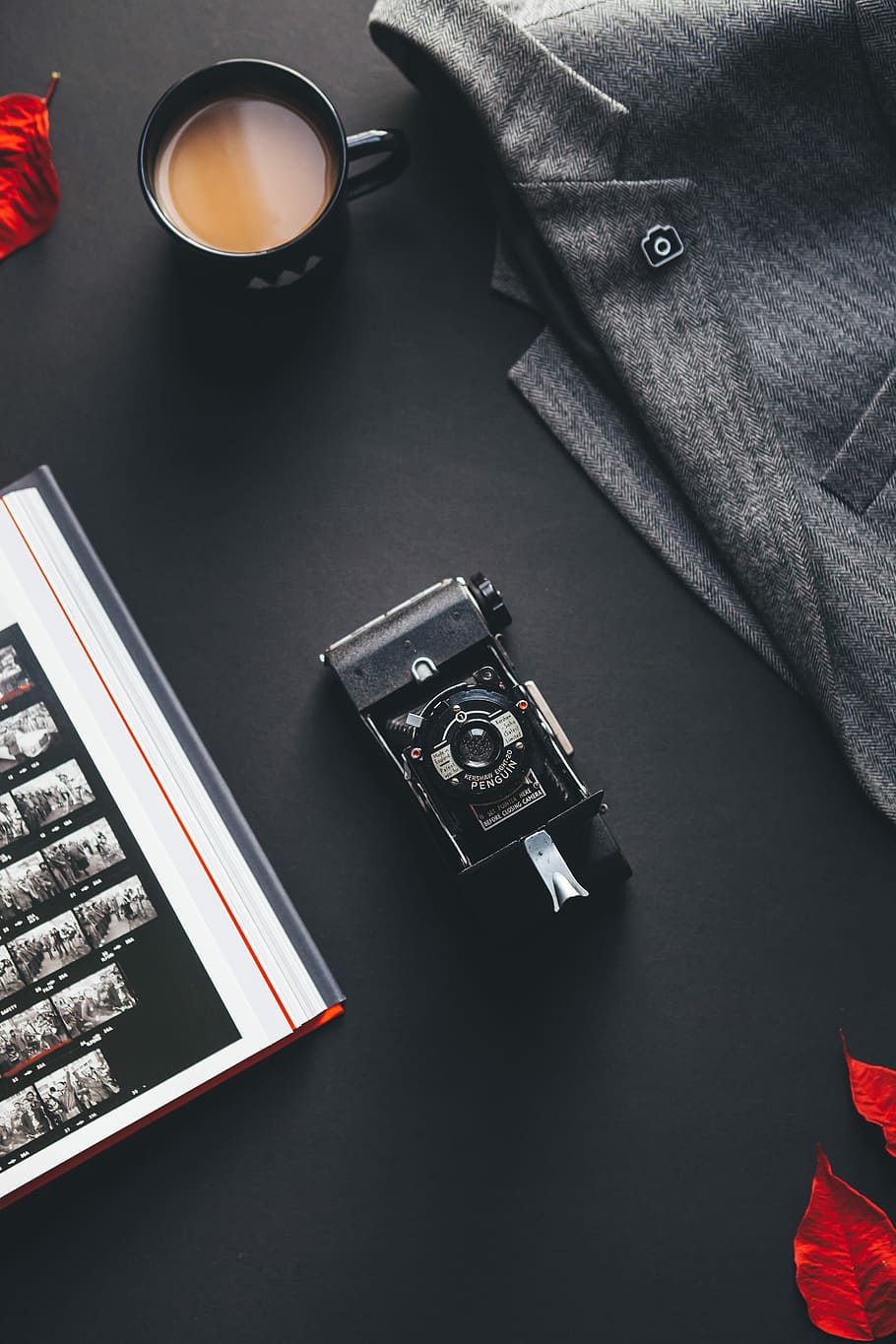 black film camera near gray suit jacket, black ceramic mug with coffee inside beside gray suit jacket and black camera on table, HD wallpaper