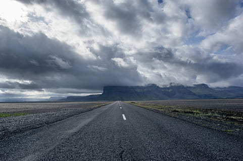 concrete road under cumulunimbus clouds, gray asphalt road, mountain HD wallpaper