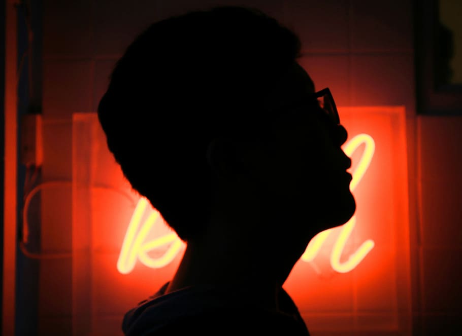 silhouette photo of man wearing sunglasses, silhouette of a person beside LED signage HD wallpaper