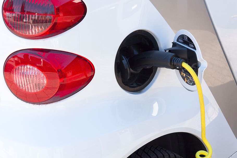 black gasoline nozzle in vehicle gas tank hole, electric car HD wallpaper