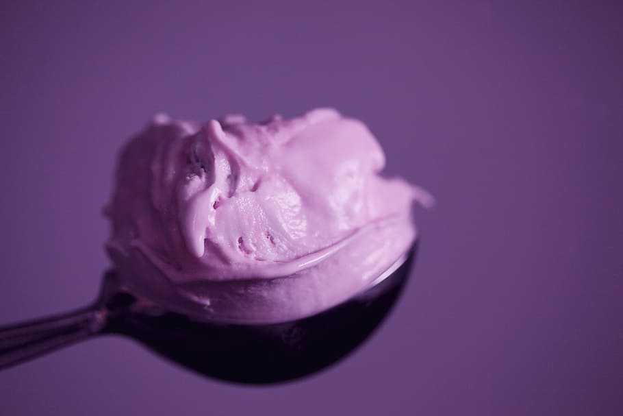 photo of ice cream, strawberry ice cream on black spoon, colour