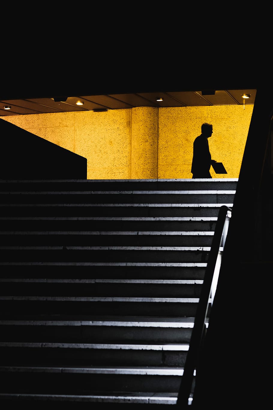 silhouette of man walking holding card, candid, staircase, yellow HD wallpaper