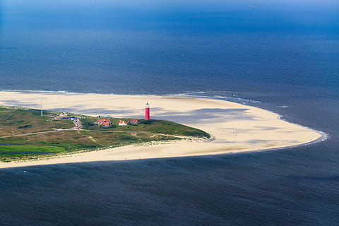 aerial photo of red and white lighthouse on seashore, texel HD wallpaper