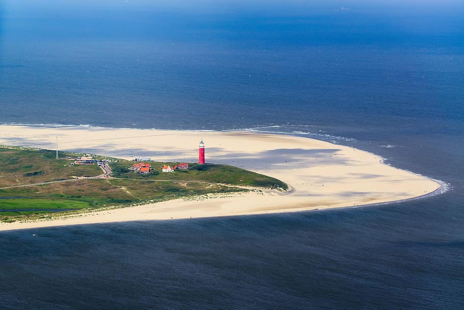 aerial photo of red and white lighthouse on seashore, texel HD wallpaper