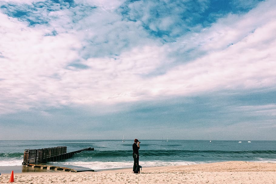 Person in Black Top Standing on Seashore Under White Clouds, beach HD wallpaper