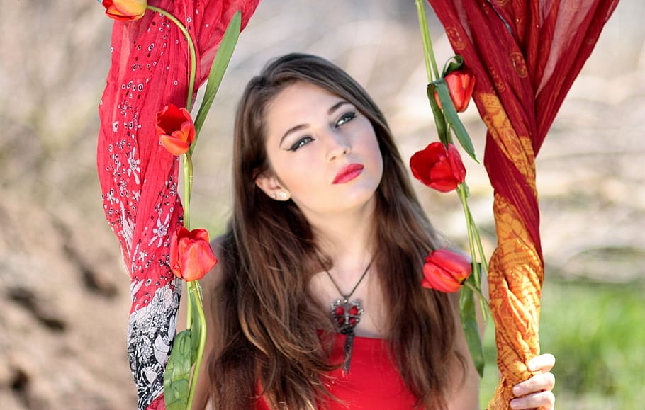 woman in red top holding red petaled flower, girl, about, blue eyes
