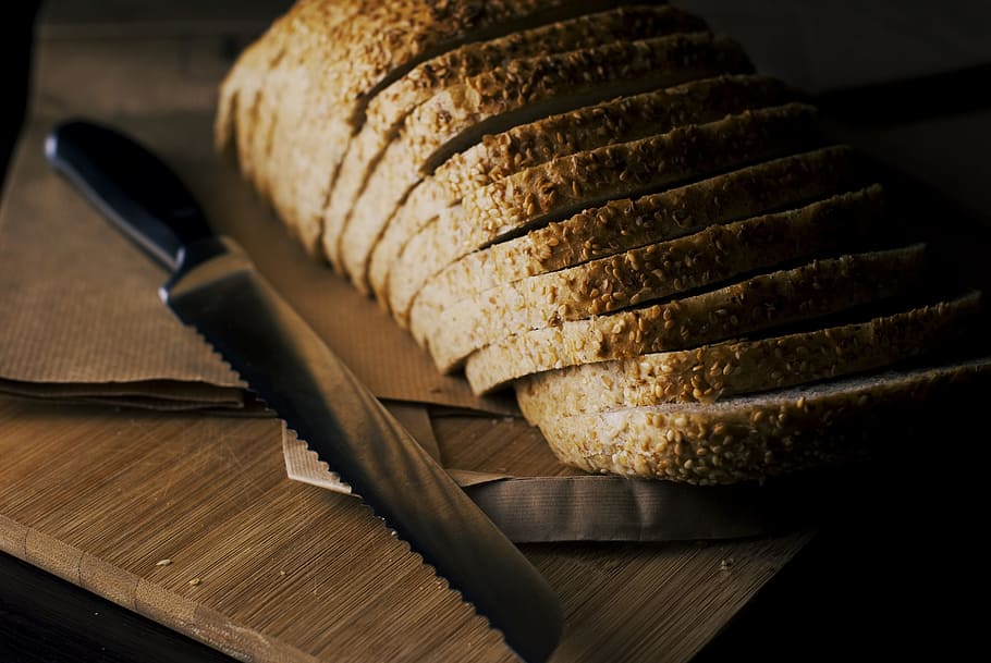 bread knife beside baked bread, sliced, cutting board, wood HD wallpaper