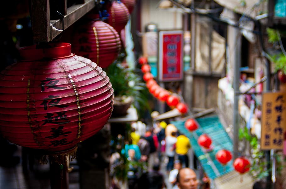 red hanging chinese lantern, round red lanterns hanging from ceiling of building during daytime