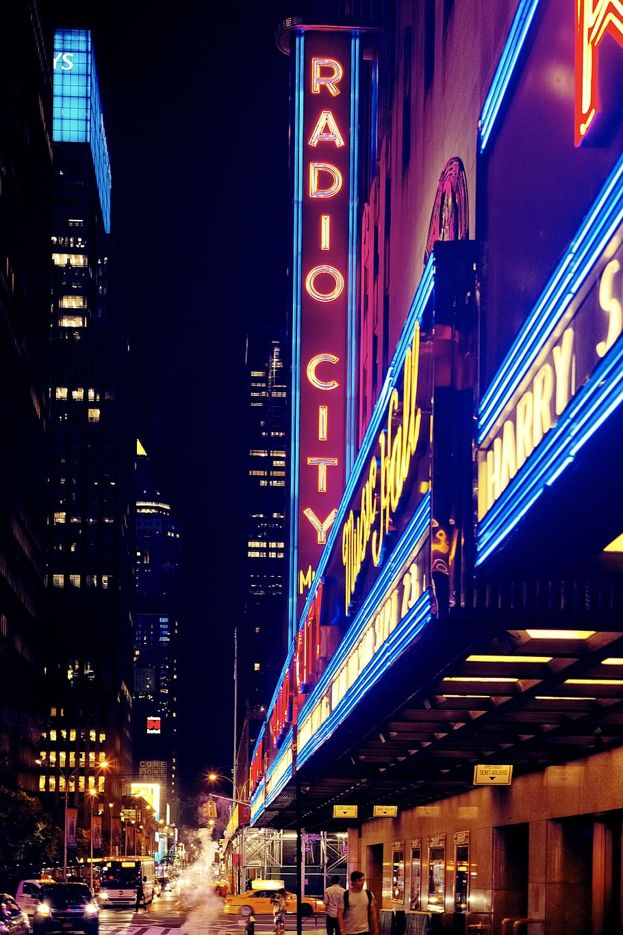 inlighted Radio City signage, high-rise building with lights
