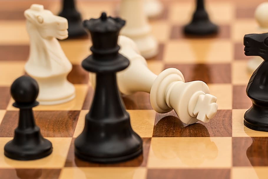 closeup photo of chessboard, checkmate, resignation, conflict