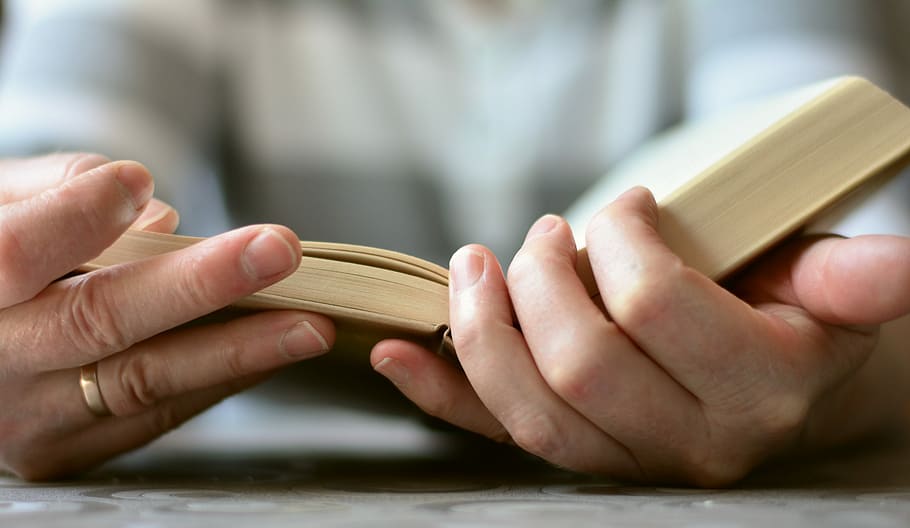 selective focus photography of person reading book, hands, open book HD wallpaper