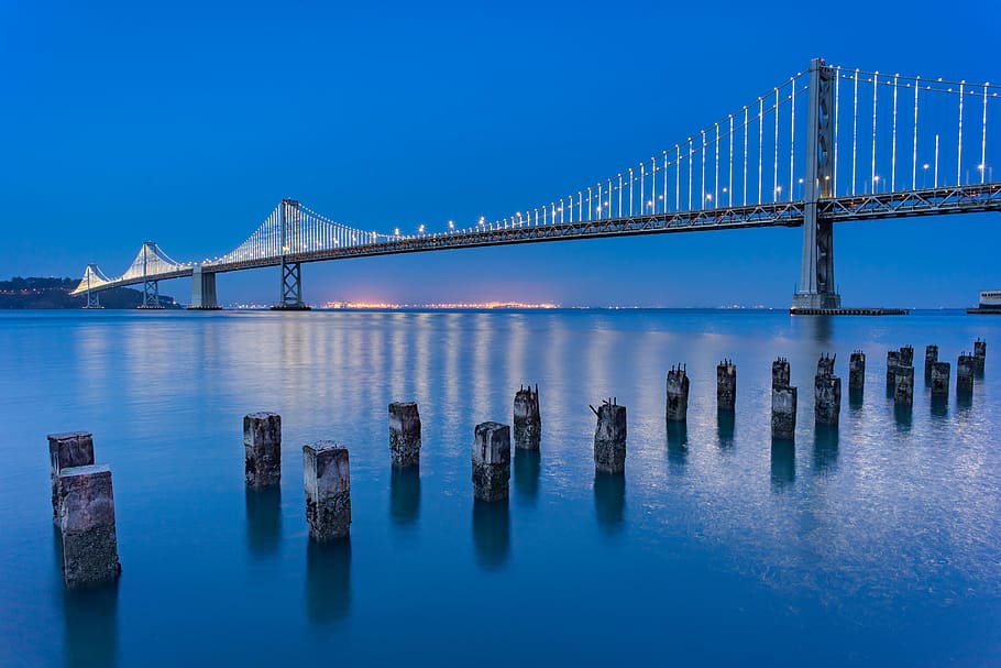 photo of Oakland Bay Bridge, bridge during blue sky, water, night HD wallpaper