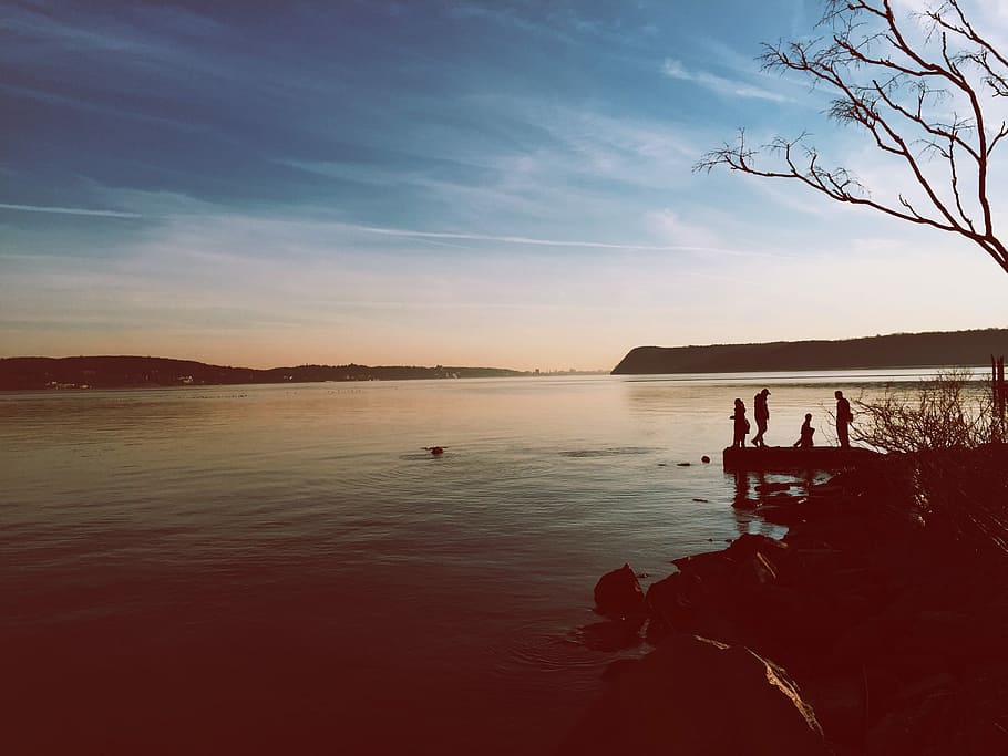 body of water near dock, silhouette photography of four people standing on dock HD wallpaper