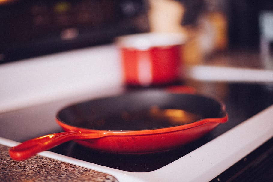 red frying pan on black stove, cooking, kitchen, oven, indoors HD wallpaper