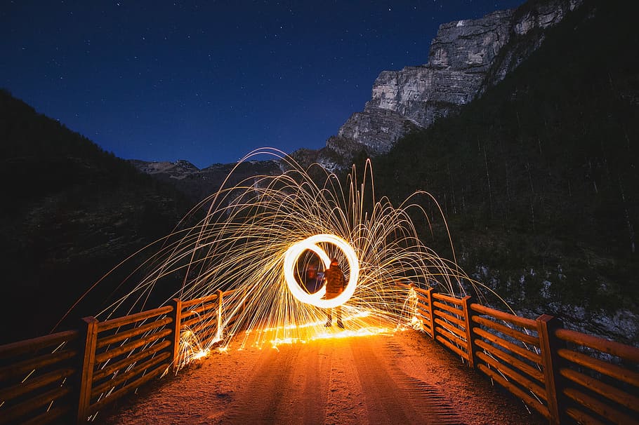 time-lapse photography of person holding steel wool on bridge, steel wool photography HD wallpaper