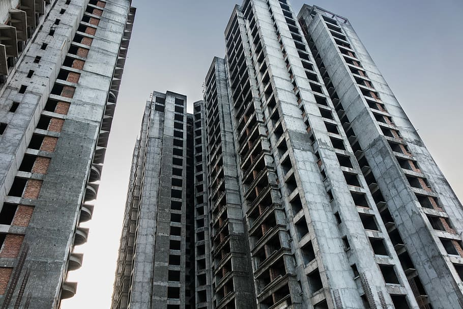 Tower block in pause phase, worm's-eye view photography of high-rise building under cloudy sky