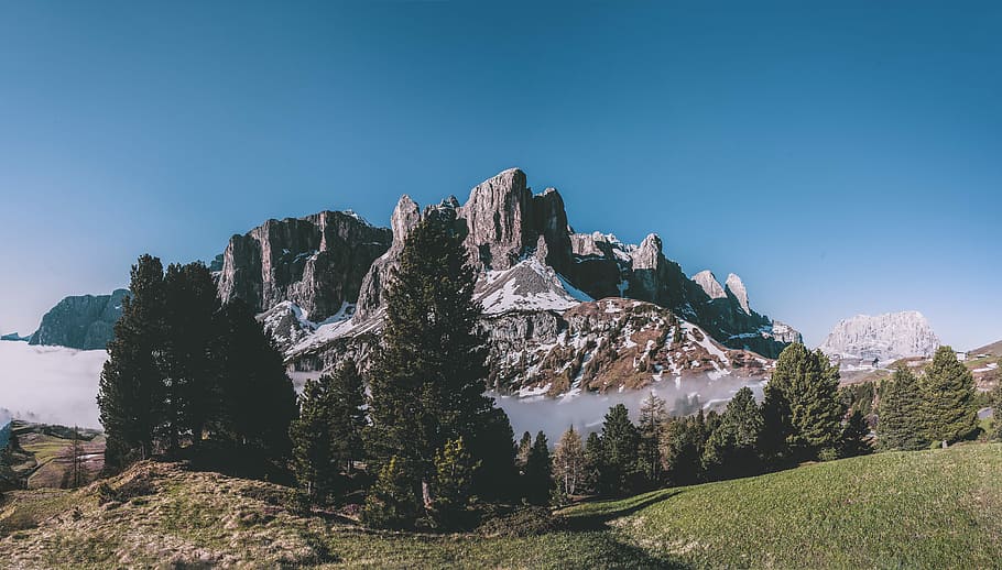 photo of mountain near trees, rock mountains under blue sky at daytime HD wallpaper