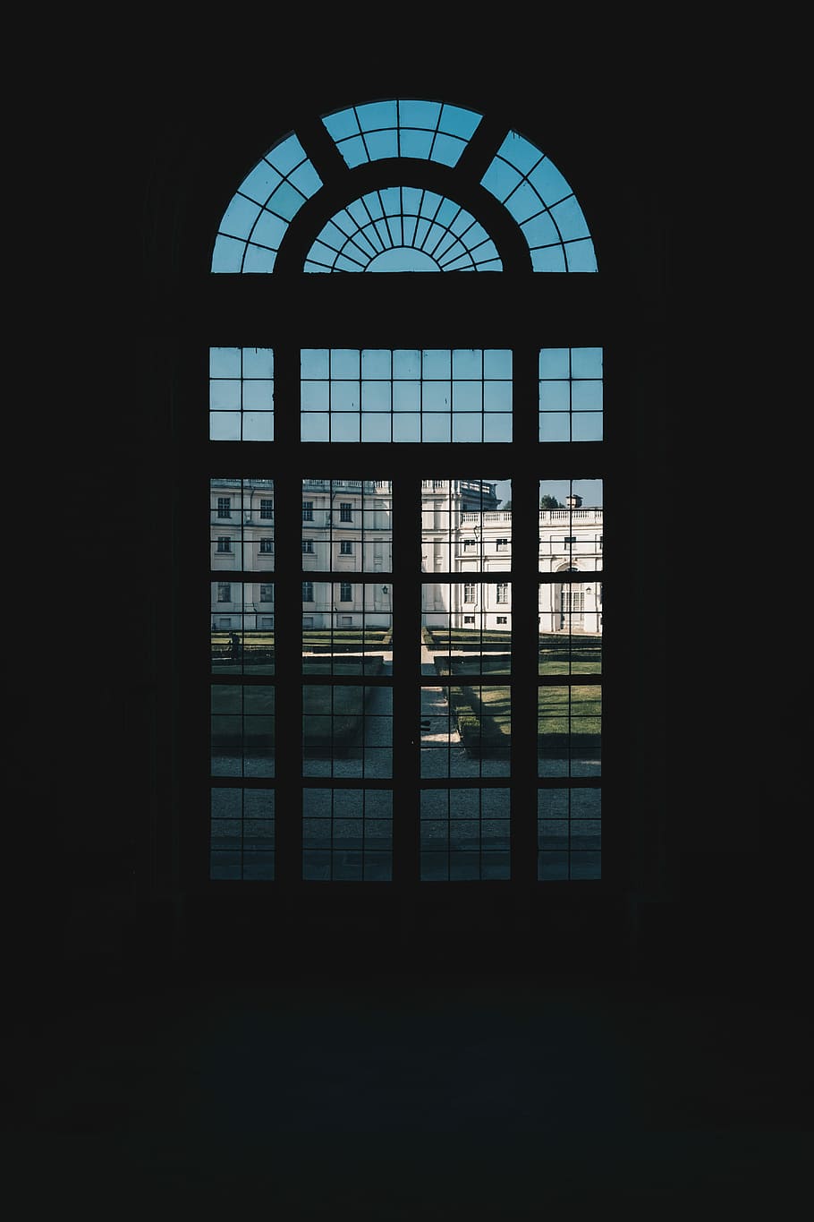 person in dark room near glass window, silhouette of window in front of white concrete building HD wallpaper