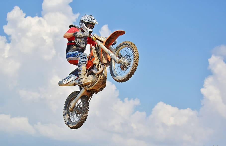 man riding motocross dirt bike, air jump, motocross rider, extreme sports