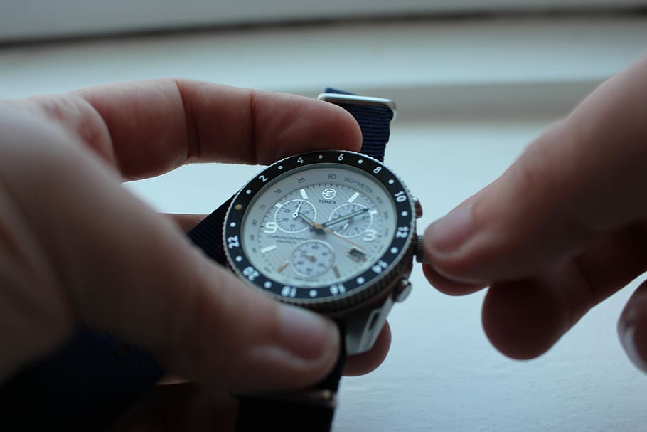 person setting the chronograph watch, person adjusting chronograph watchn HD wallpaper
