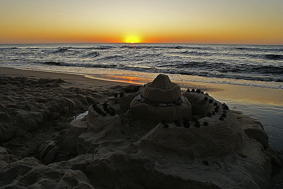 sand castle near body of water during golden hour, sunset, sea, HD wallpaper