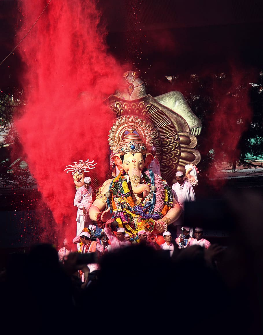 Ganesha statue surrounded by people, Lord Ganesha figurine, festival
