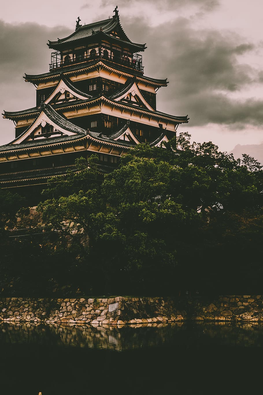 beige and black concrete castle, brown and black temple under cloudy sky