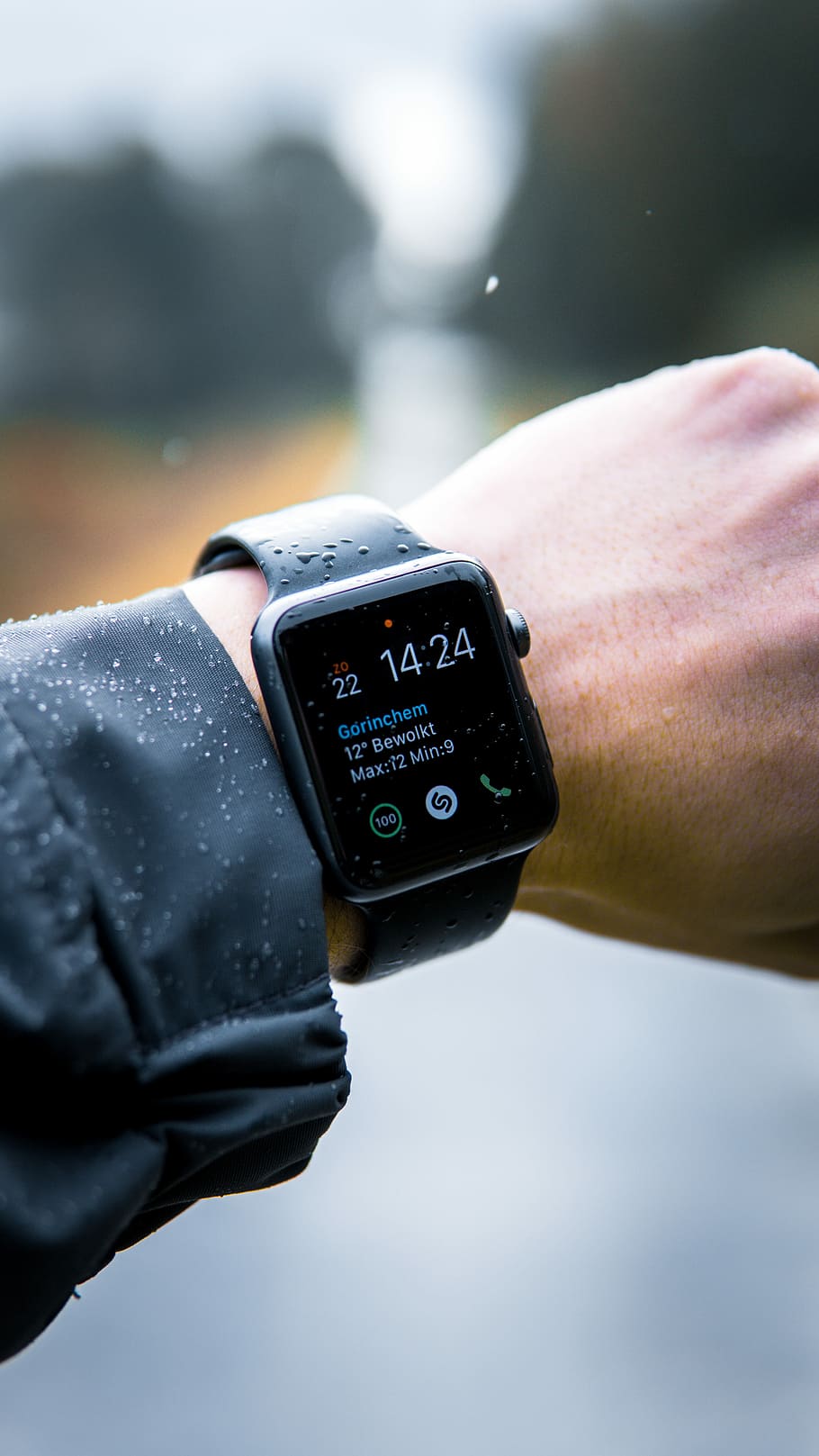 person wearing Apple Watch at 14:24, black Apple Watch with sports band