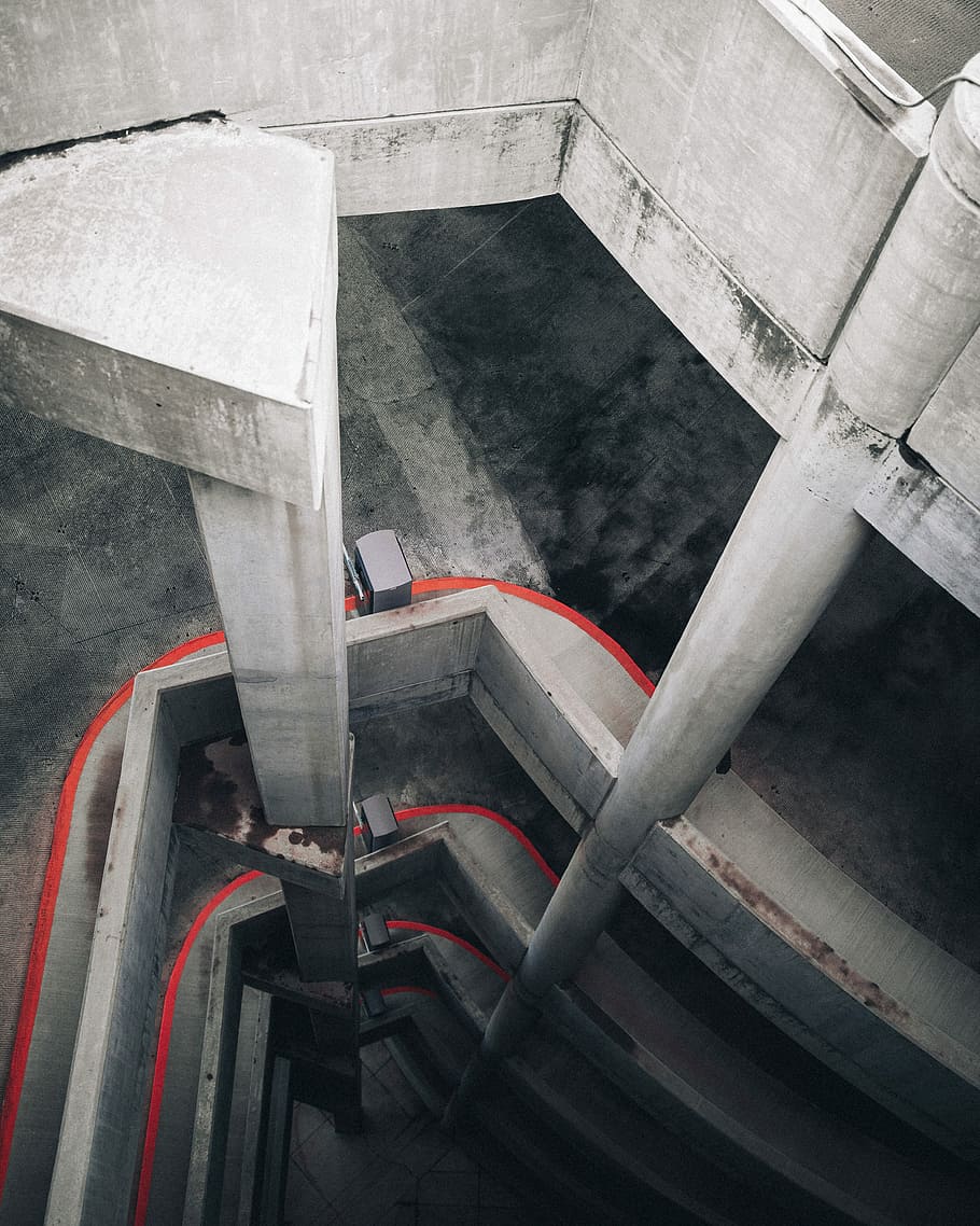 gray and red concrete building at daytime, aerial view photography of car park HD wallpaper